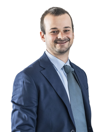 Frau mit Blazer, die die Arme verschränkt hält, vor weißem Hintergrund.